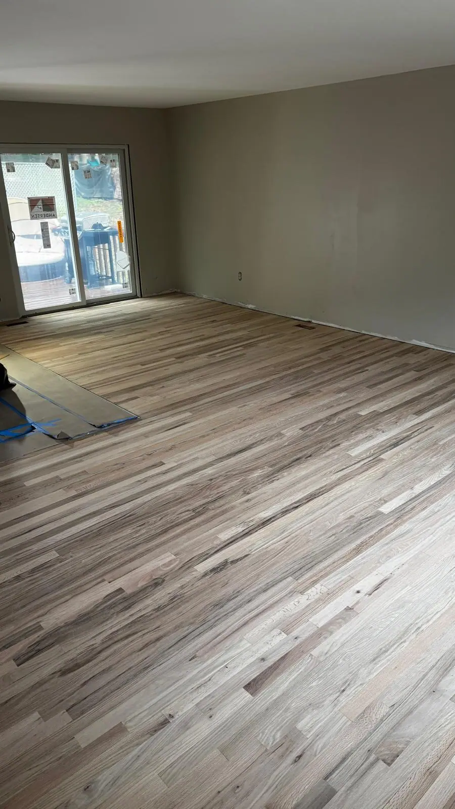 Oak hardwood floor sanding, staining, and refinishing in open-plan living room. — 2