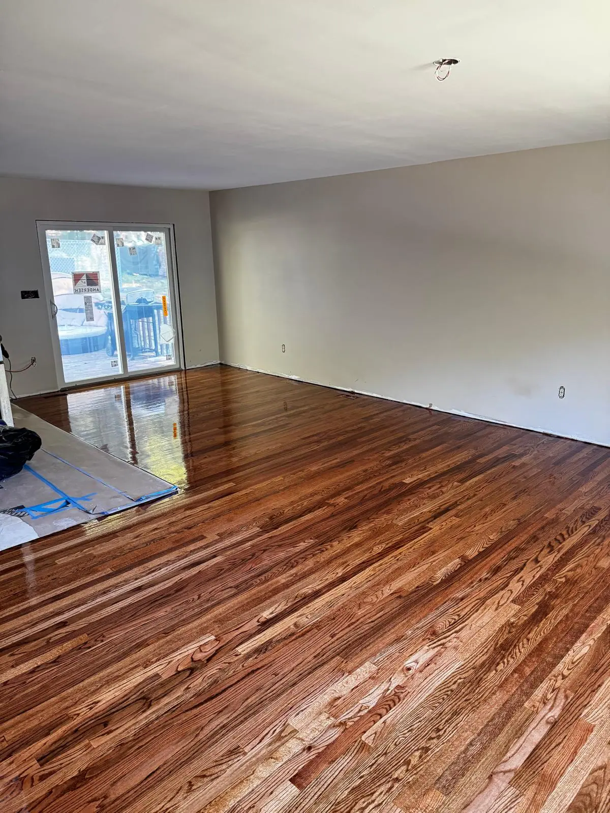 Oak hardwood floor sanding, staining, and refinishing in open-plan living room. — 3
