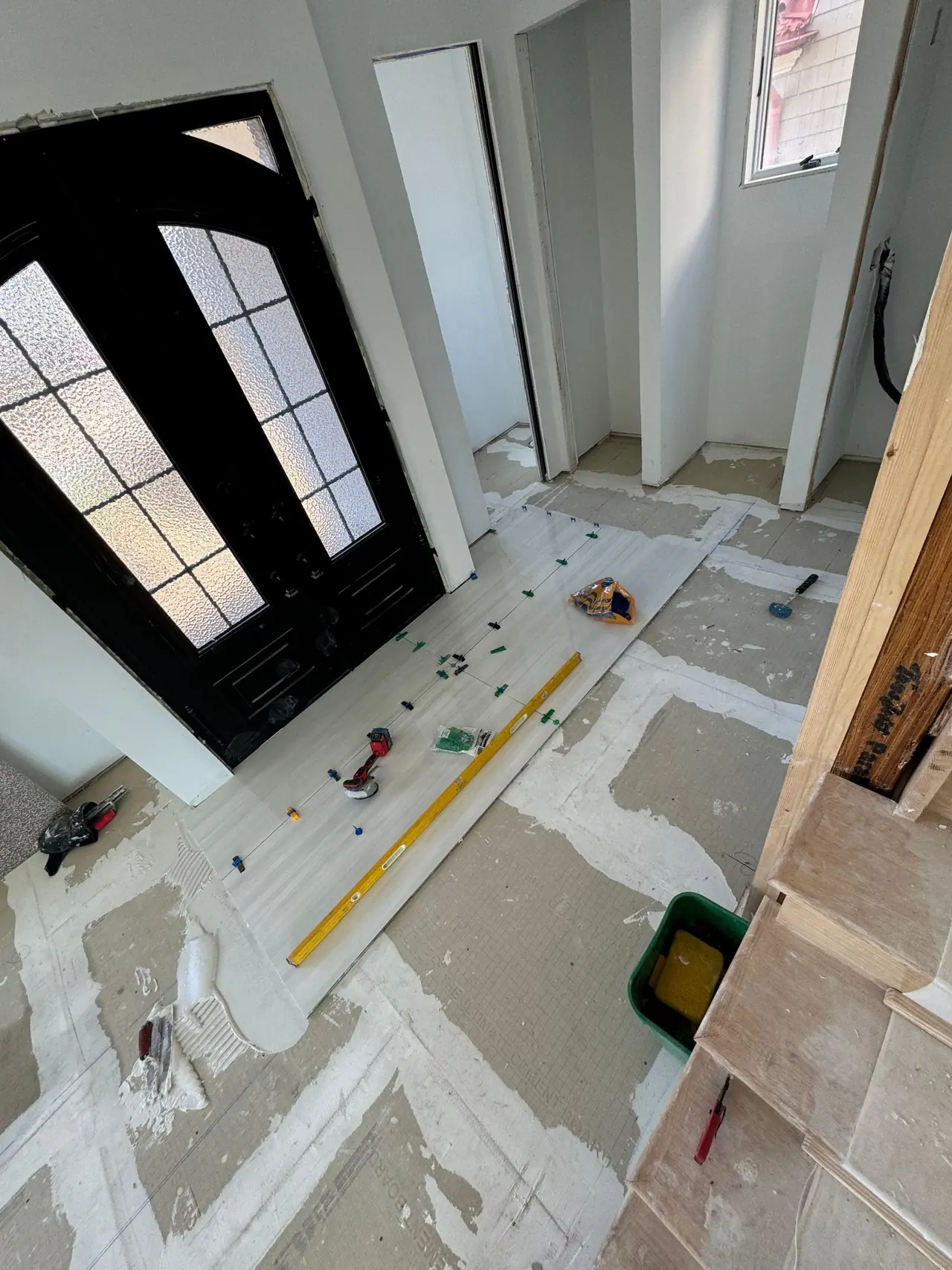 Full main floor build — radiant heating system, cement backer board prep, and large-format polished porcelain tile with waterfront views. — 3