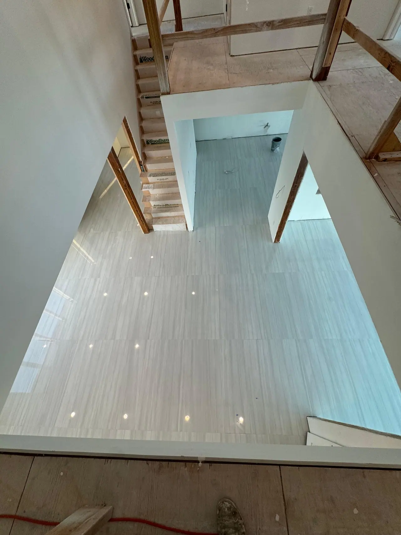 Full main floor build — radiant heating system, cement backer board prep, and large-format polished porcelain tile with waterfront views. — 4