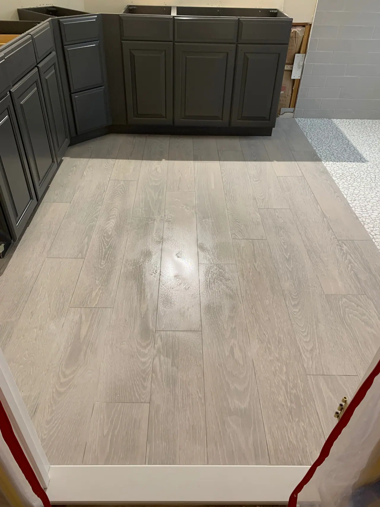 Walk-in shower with subway wall tile, pebble mosaic floor, and recessed niche detail. — 5